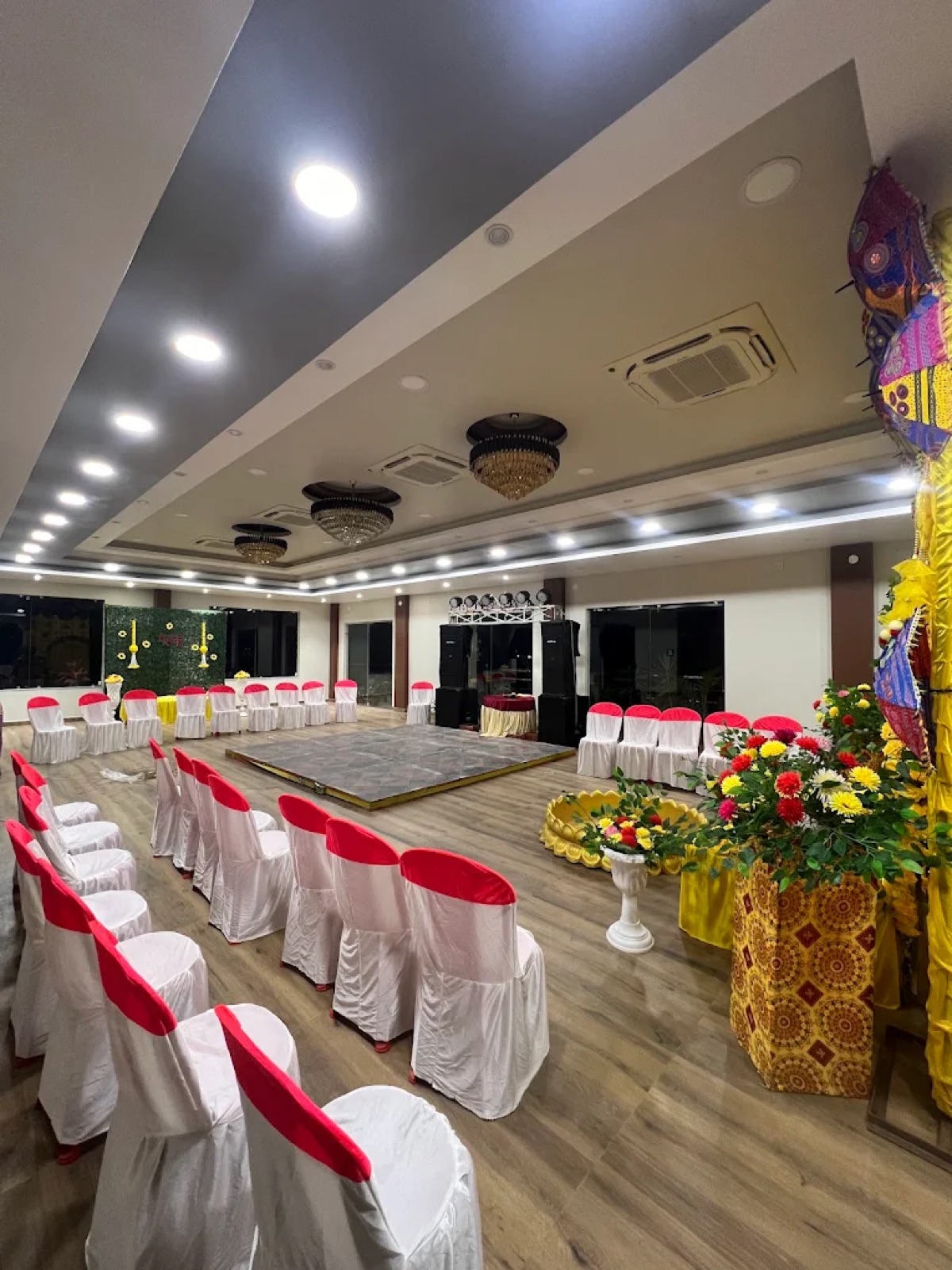Banquet hall set up with stage and seating for a function at Shri Nath Palace, Deoghar