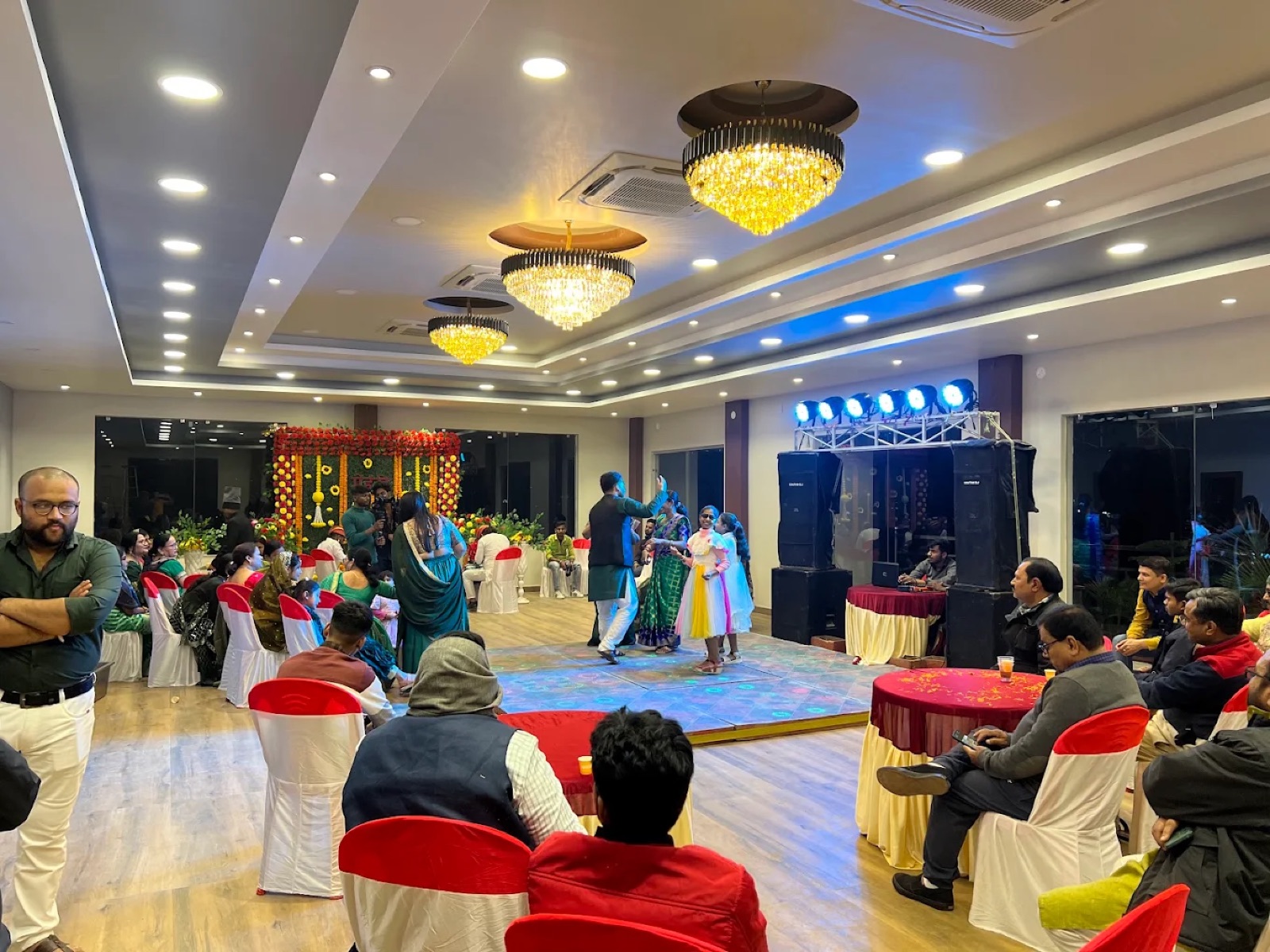 Guests celebrating at a sangeet function in the banquet hall of Shri Nath Palace, Deoghar